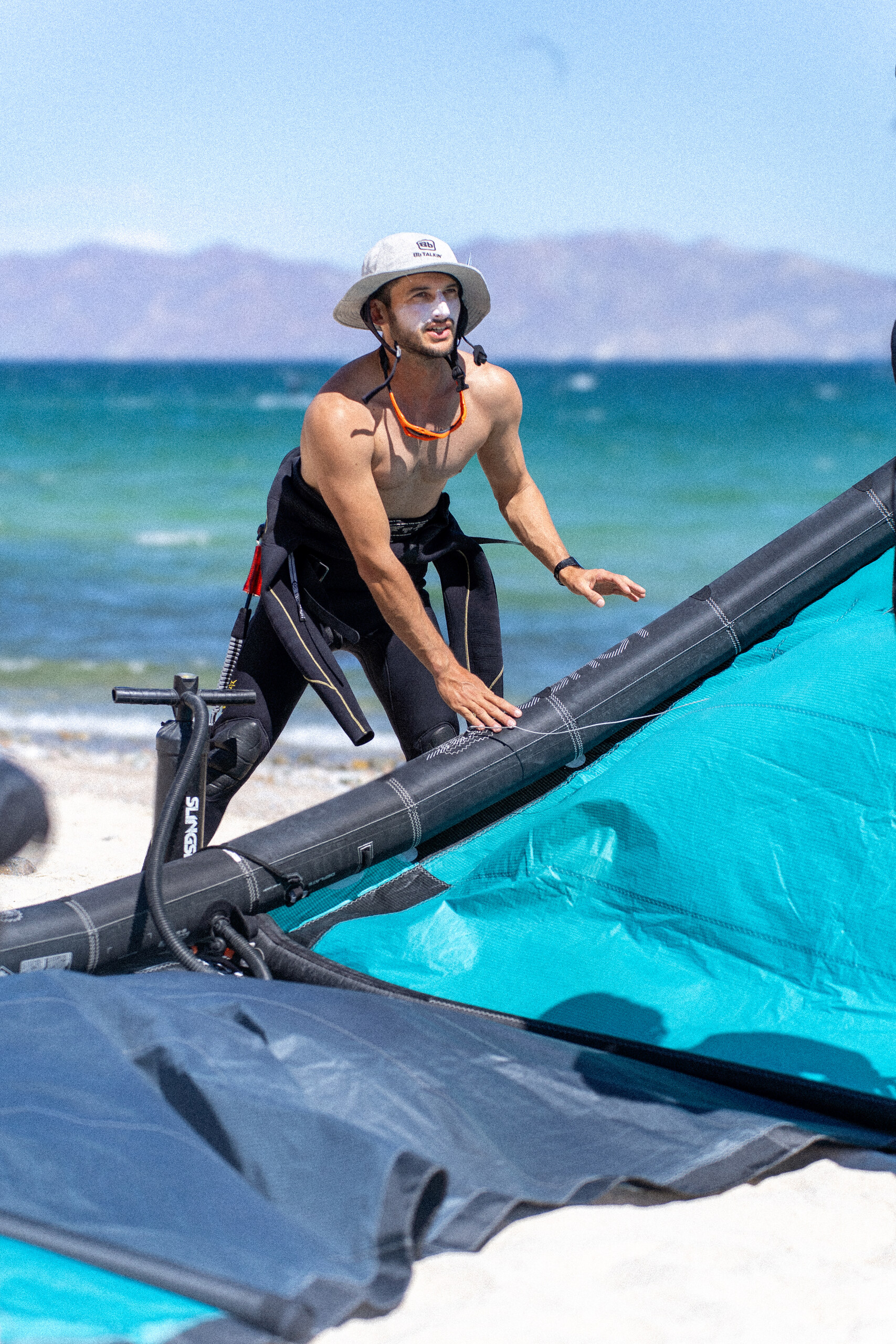 Windsalt instructor preparing kiteboarding equipment on the beach